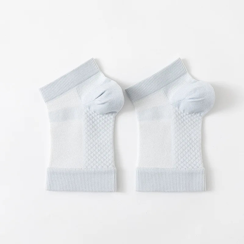 Pair of white therapeutic compression socks for foot and ankle pain relief