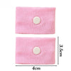 Pink knitted wristband with a circular button for anti-nausea relief