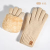 A pair of beige knit thermal gloves shown against a white background.
