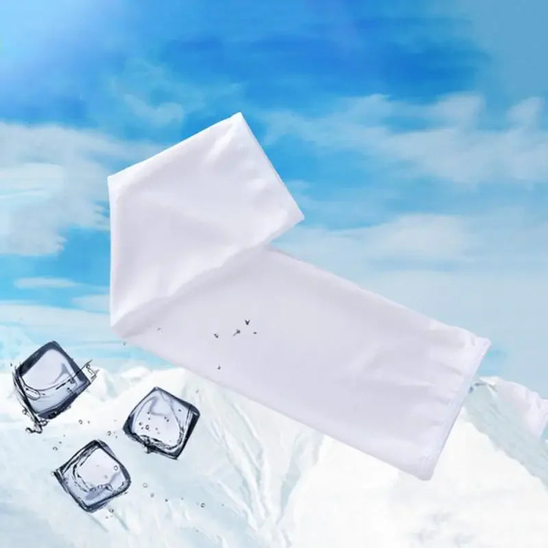 White UV protection arm sleeves lying on a snowy mountain landscape under a blue sky.