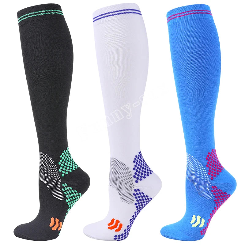 Three pairs of medical grade compression socks in black white and blue with patterned toes