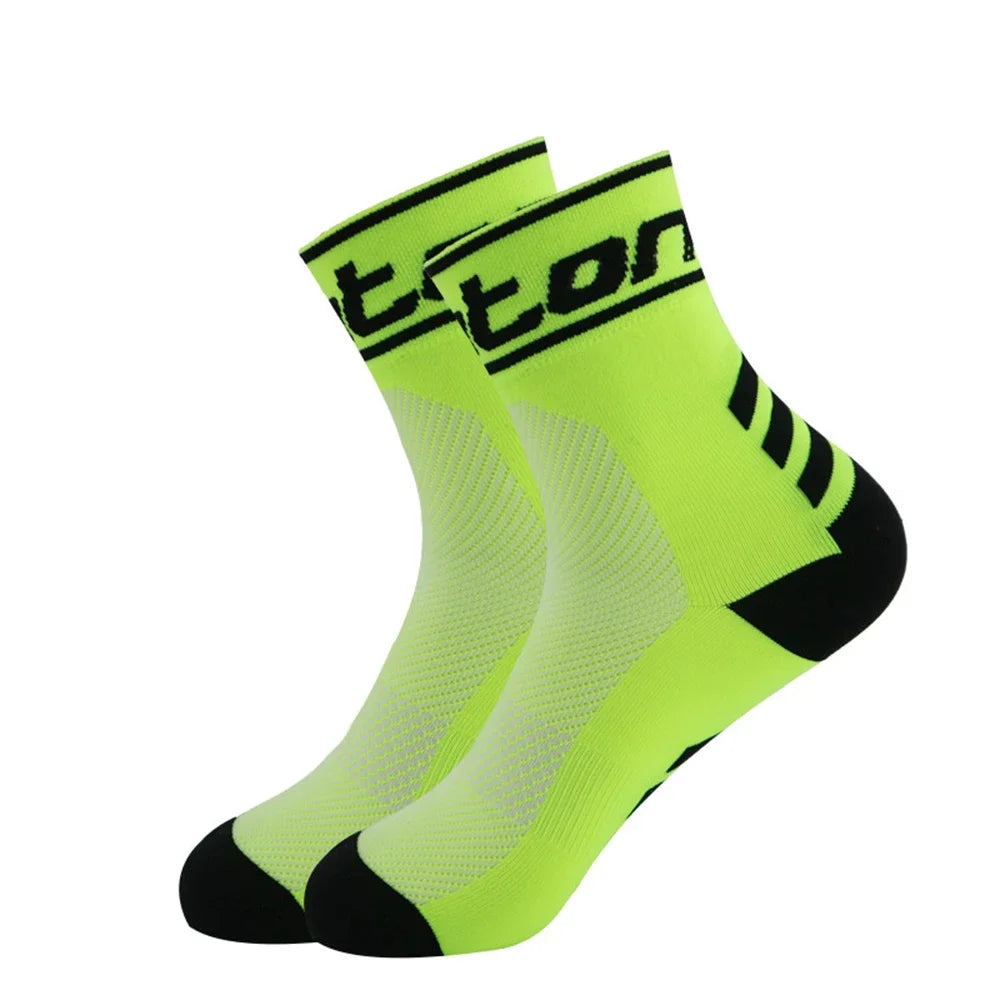 A pair of neon yellow and black performance cycling and running socks shown from the side.