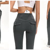 A woman models high-waisted gray flared yoga leggings with multiple pockets.