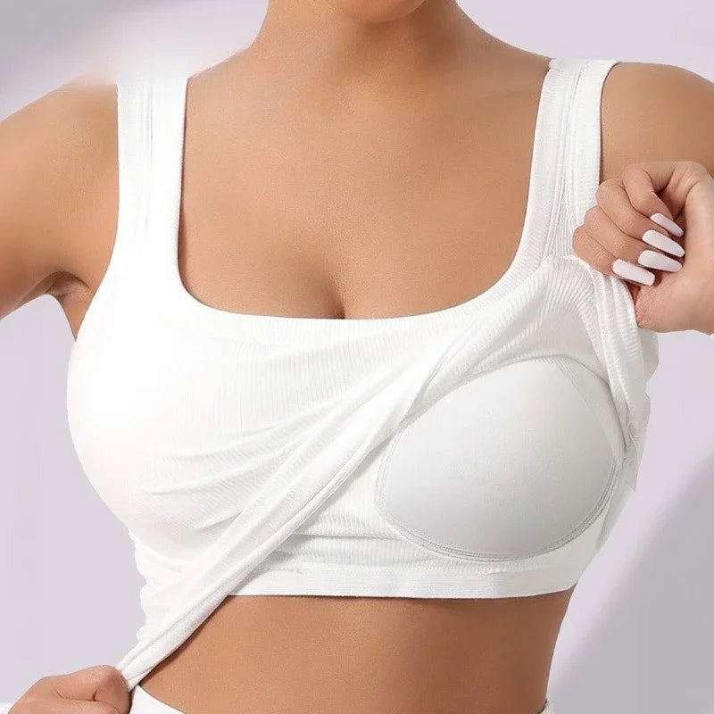 White racerback padded tank top worn by a woman, showing the front view of the garment.