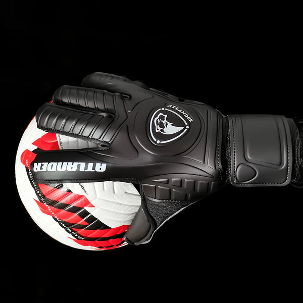 A pair of black latex goalkeeper gloves with red and white accents shown against a black background.