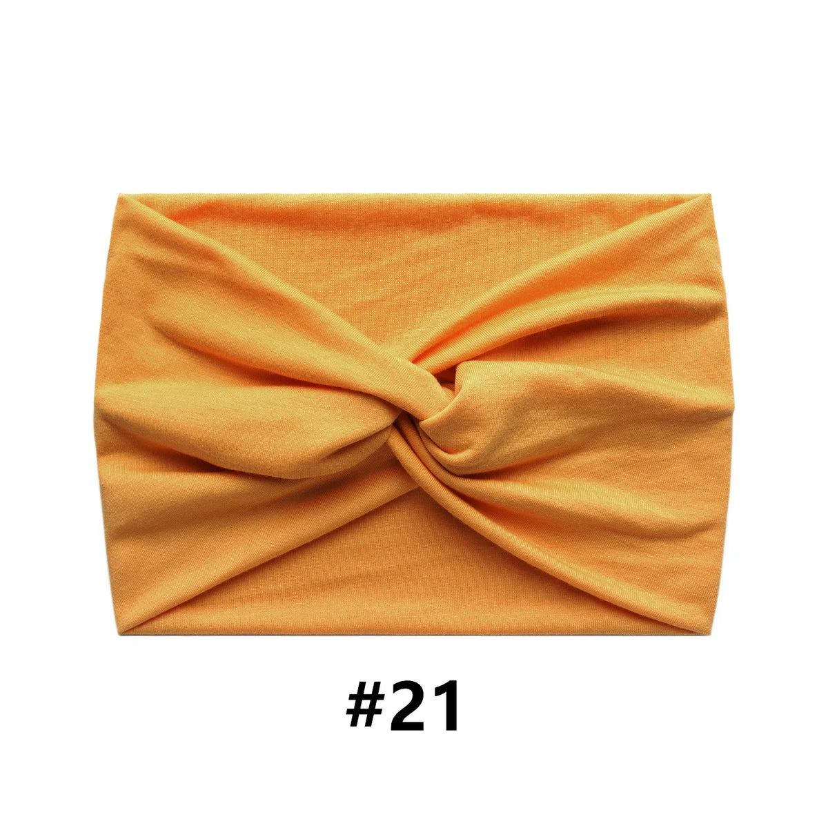 Orange boho wide turban headband folded and displayed on a white background.