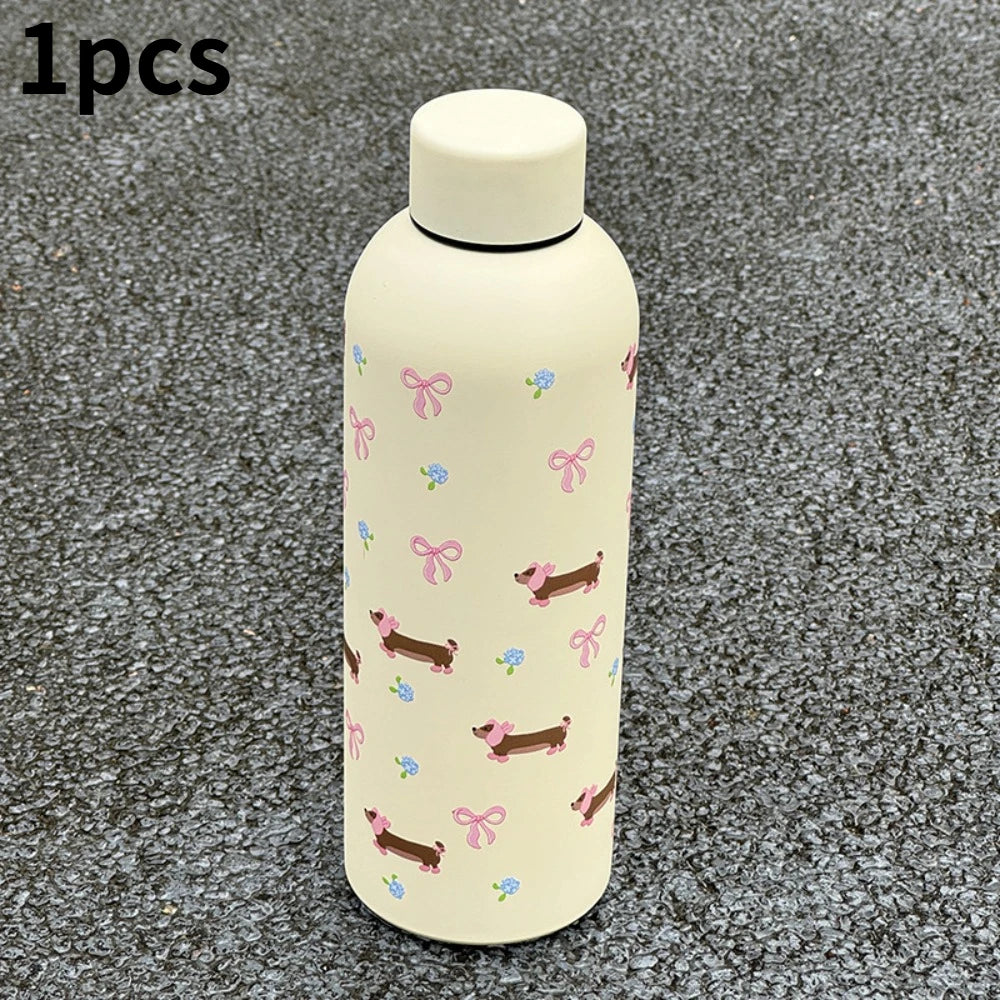 Taza térmica de acero inoxidable doble pared color beige claro con estampados florales y de animales rosas