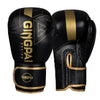 A pair of black boxing training gloves with gold accents and a textured surface.