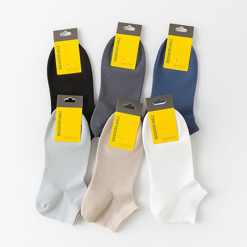 Six pairs of men's combed cotton socks in various colors and shades displayed with packaging.
