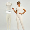Model in cream sports suit with fitted t-shirt and matching pants.