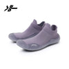 A pair of grey summer quick-dry slip-on beach and gym shoes shown from the side.