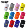 A collection of colorful and textured athletic wristbands in various colors including white, gray, pink, yellow, green, blue,