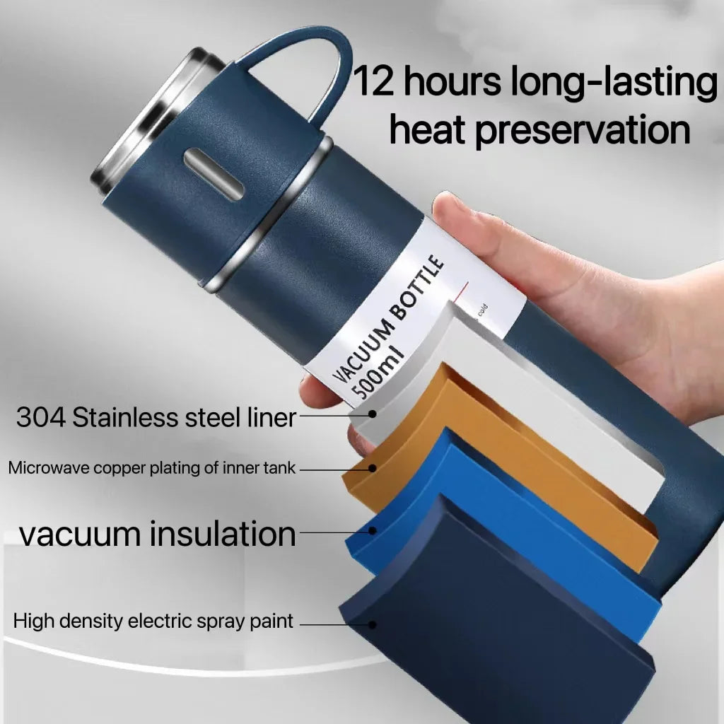 A hand holds a dark blue vacuum bottle with a silver lid, demonstrating its heat preservation features.