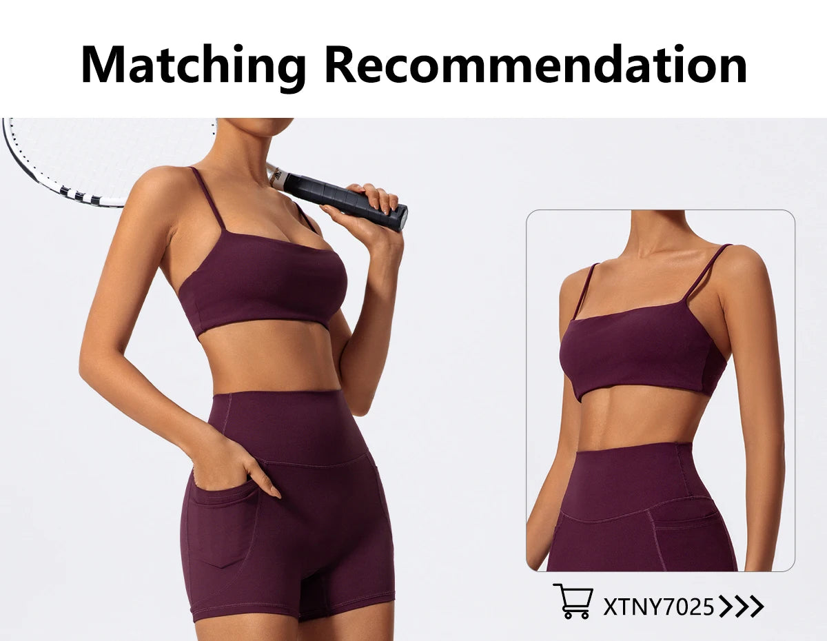 A model wearing a dark purple high-waist yoga or workout set consisting of a sports bra top and matching shorts.