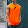 A muscular man wearing a bright orange sleeveless sports tank top with black stripes, standing outdoors.