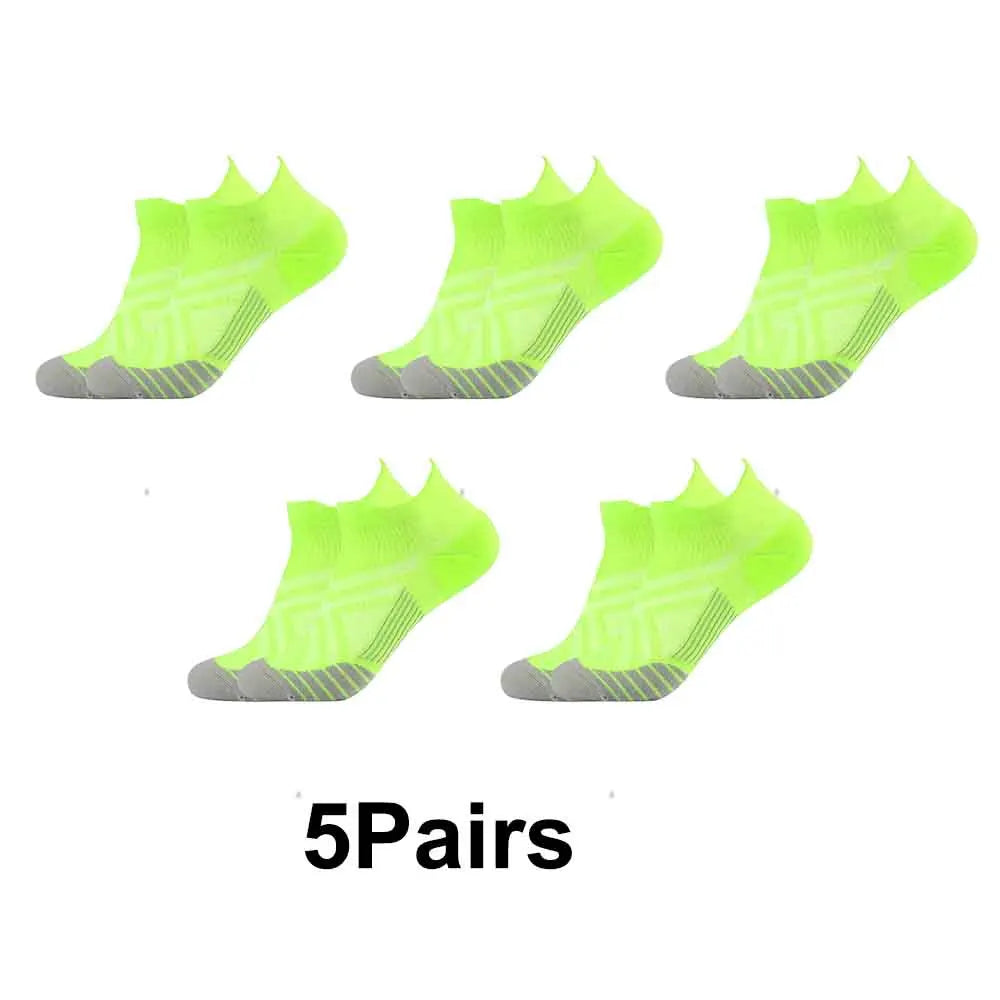 Five pairs of neon yellow compression sports socks displayed side by side.