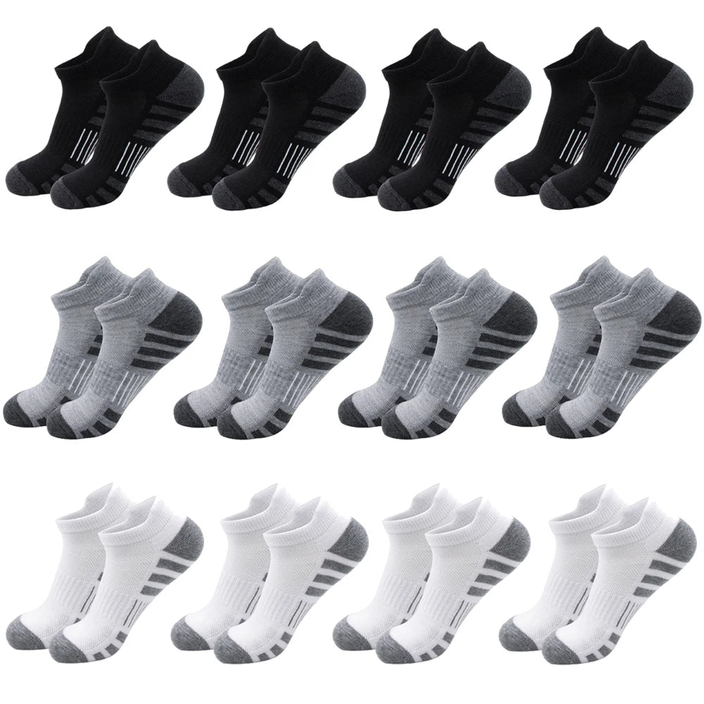 A collection of black and gray athletic running socks for men and women shown in various styles.