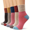A stack of various colored thermal knit crew socks displayed vertically.