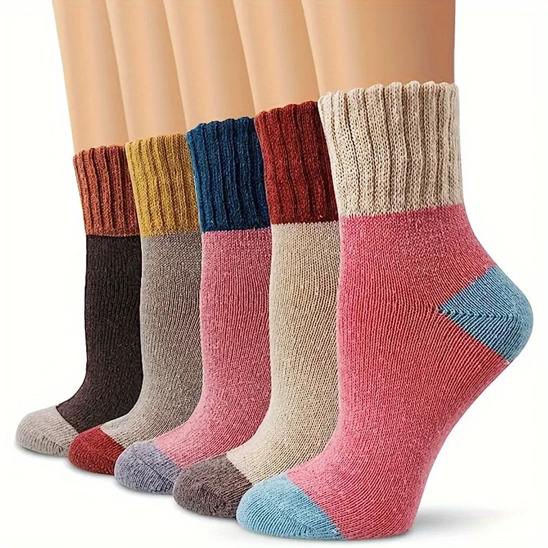 A stack of various colored thermal knit crew socks displayed vertically.