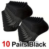 Ten pairs of black performance compression ankle socks displayed in a stack.
