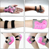 A set of pink protective gear including a helmet, knee pads, and wrist guards for children.