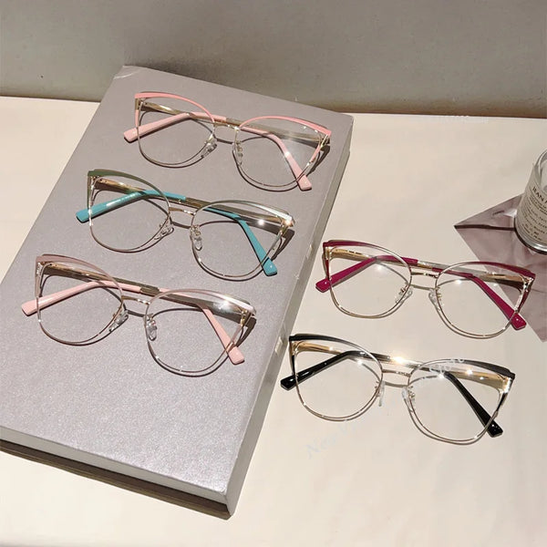 A collection of cat-eye blue light blocking glasses in various colors displayed on a white surface.