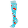 A pair of light blue compression socks featuring a repeating pattern of orange and white reindeer.