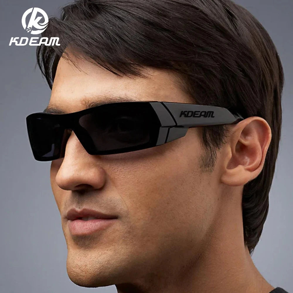 A man wearing black KDEAM polarized sports sunglasses against a gray background.