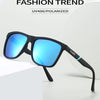 A pair of black polarized sunglasses with bright blue lenses resting on a white surface.