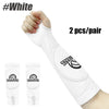 Pair of white padded volleyball arm sleeves shown on an arm.