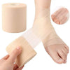 A hand is applying a roll of beige foam athletic tape wrap around a foot and ankle.