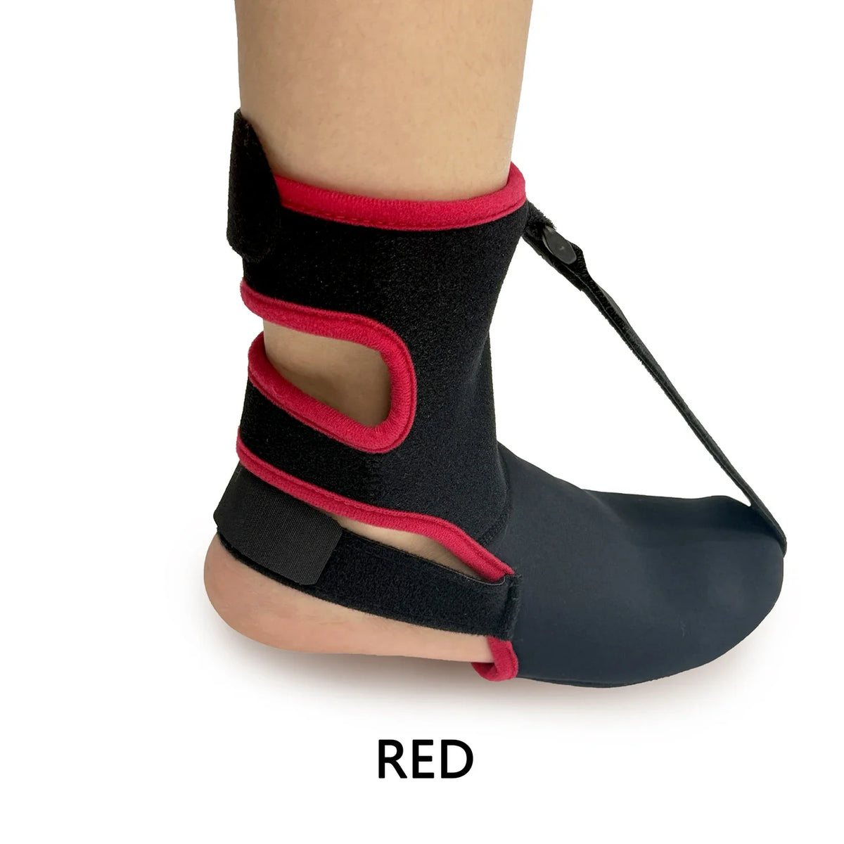 A close-up of a black night splint sock with red accents, shown on a foot.