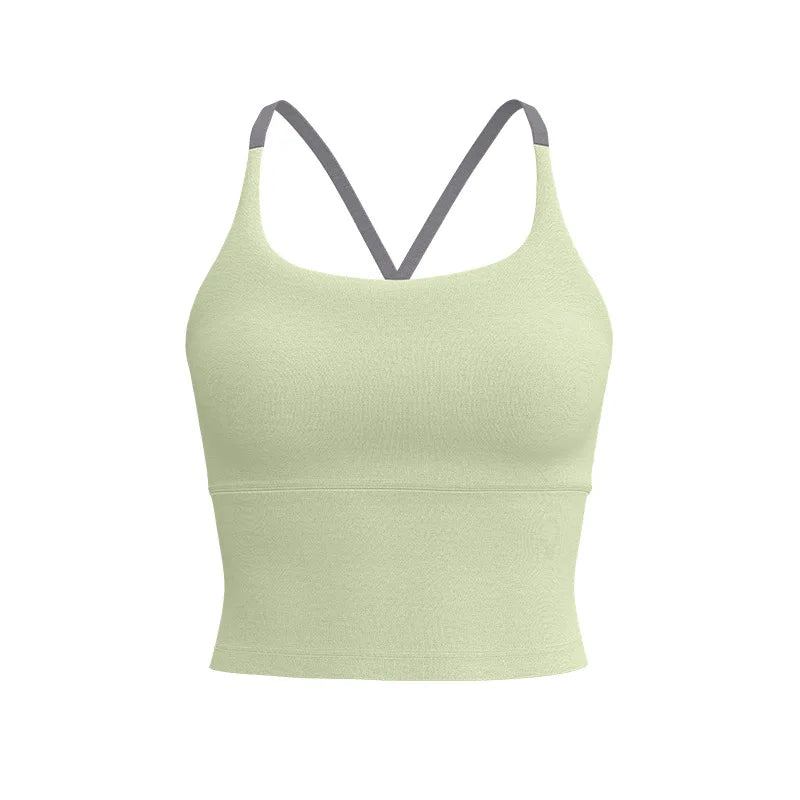 A light sage green supportive women's sports bra with thin gray straps.
