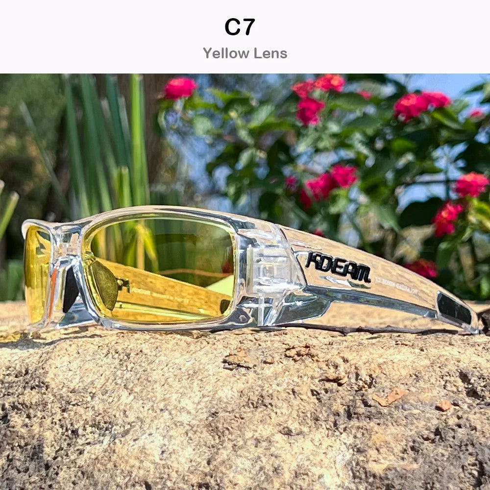 A pair of clear yellow lens sunglasses resting on a rough, light-colored rock outdoors.