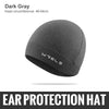 A dark gray wool knit beanie hat shown flat lay.
