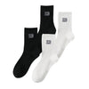 A set of three black and white men's classic crew socks with the number 23 visible on each.