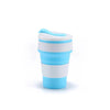 A white and light blue reusable silicone collapsible coffee cup with a lid.
