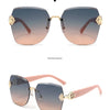 A pair of light brown framed sunglasses with gold accents shown in a studio setting.