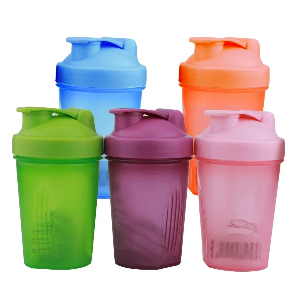 A collection of five portable protein shaker bottles in various colors including blue, orange, lime green, purple, and pink.