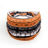 Bohemian stretch cotton headband featuring patterned fabric in black, orange, and white.