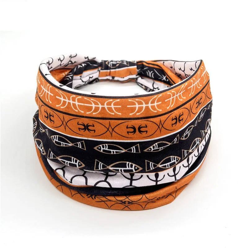 Bohemian stretch cotton headband featuring patterned fabric in black, orange, and white.