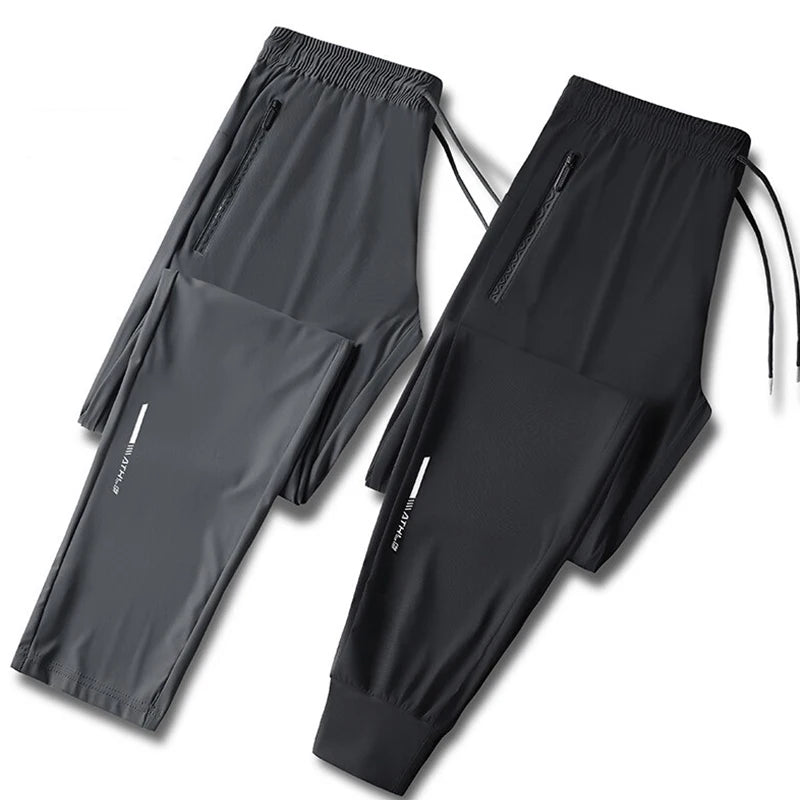 Black men's ice silk performance pants shown flat lay with a folded version