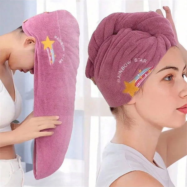 A woman is shown using a pink embroidered rainbow star hair drying cap on her head.