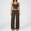 A woman wearing a dark olive green women's premium fitness tracksuit top and matching pants.