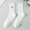 A pair of white men's athletic crew socks with a red embroidered logo on the calf.