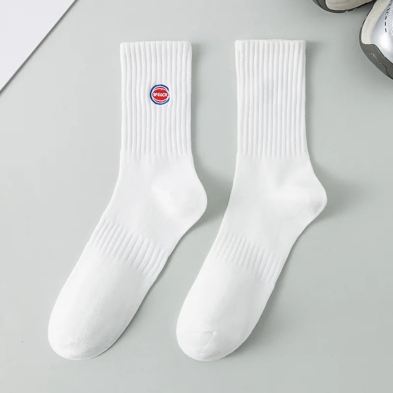 A pair of white men's athletic crew socks with a red embroidered logo on the calf.