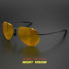 A pair of amber tinted polarized aviator sunglasses resting on a dark surface.