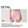 Pink high-waisted knit fitness shorts shown on a model, highlighting the stitching and fit.