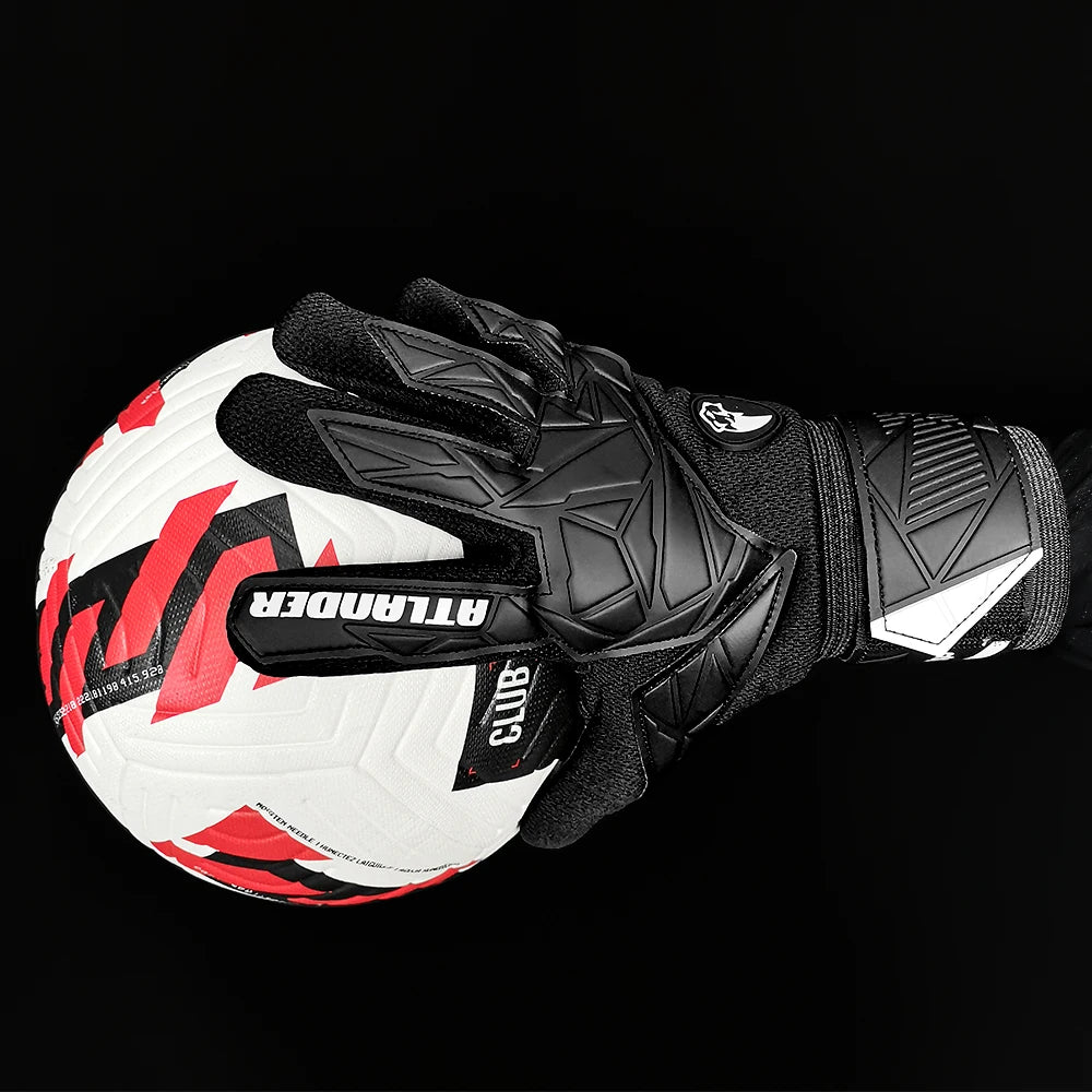 Black and white latex goalkeeper gloves with a wrist strap shown against a black background.