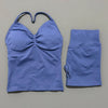 A purple women's seamless fitness set consisting of a cropped top and matching leggings.